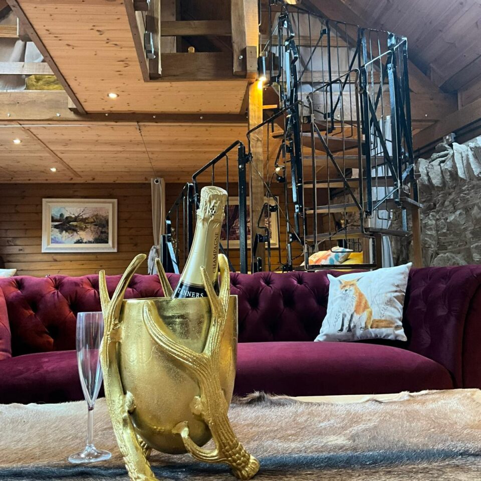 inside the glamping lodge with champagne in foreground