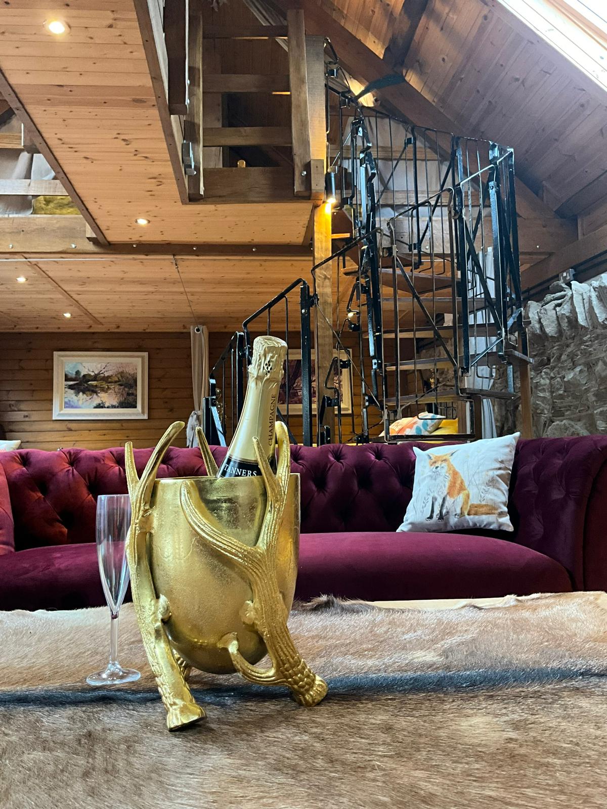 inside the glamping lodge with champagne in foreground