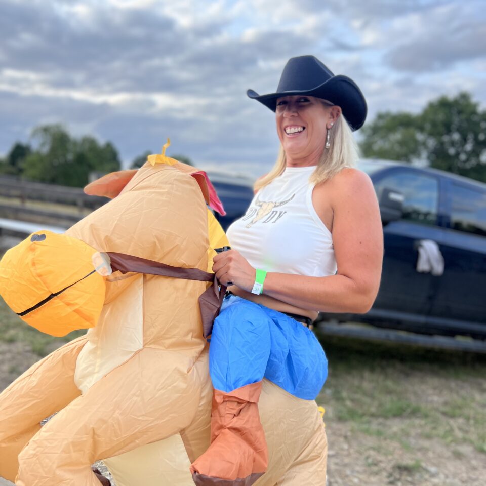 hen party goer in inflatable horse fancy dress
