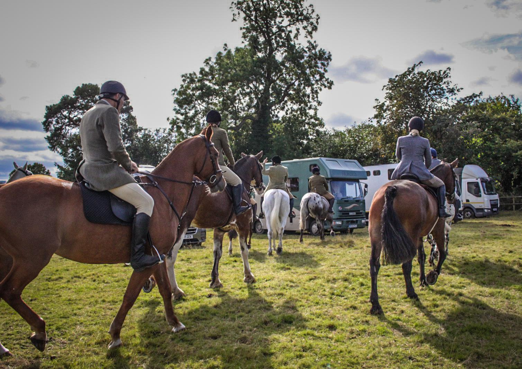 bank farm horses and riders at a trail hunt meet